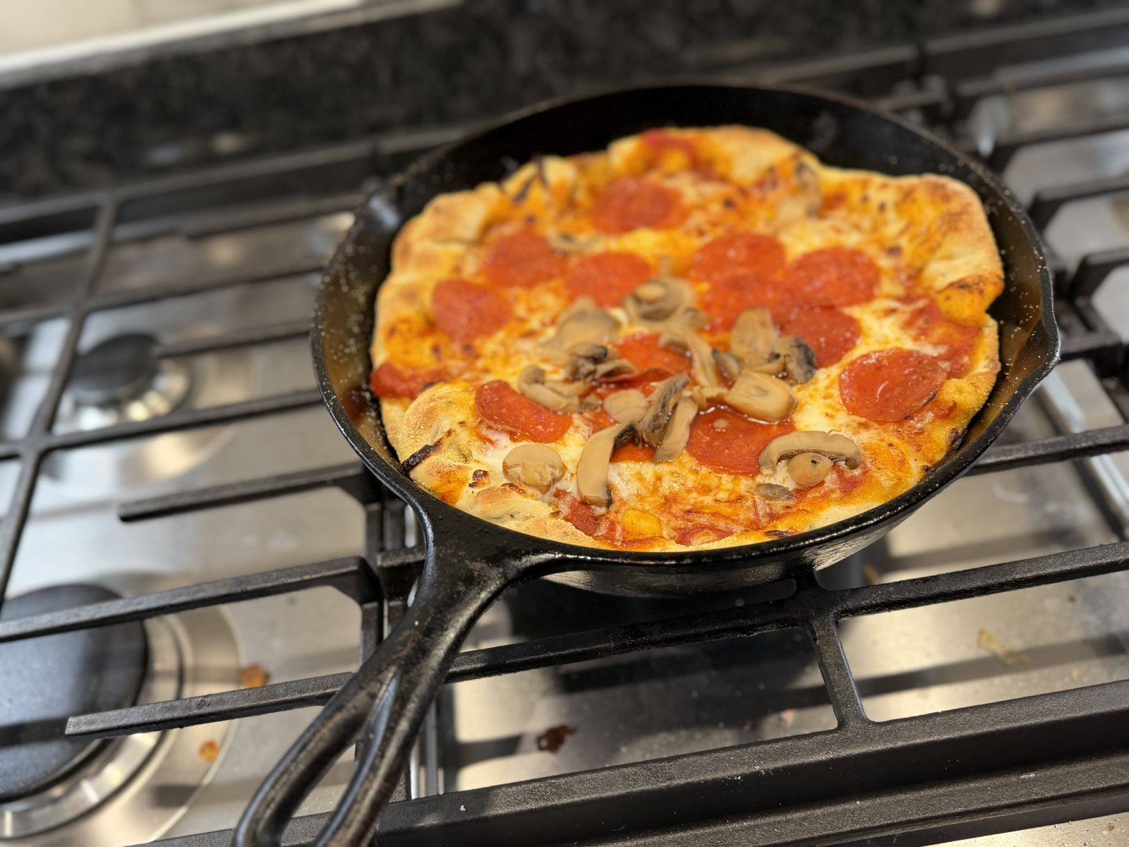 Cast-iron hybrid pizza with crisp bottom and browned top