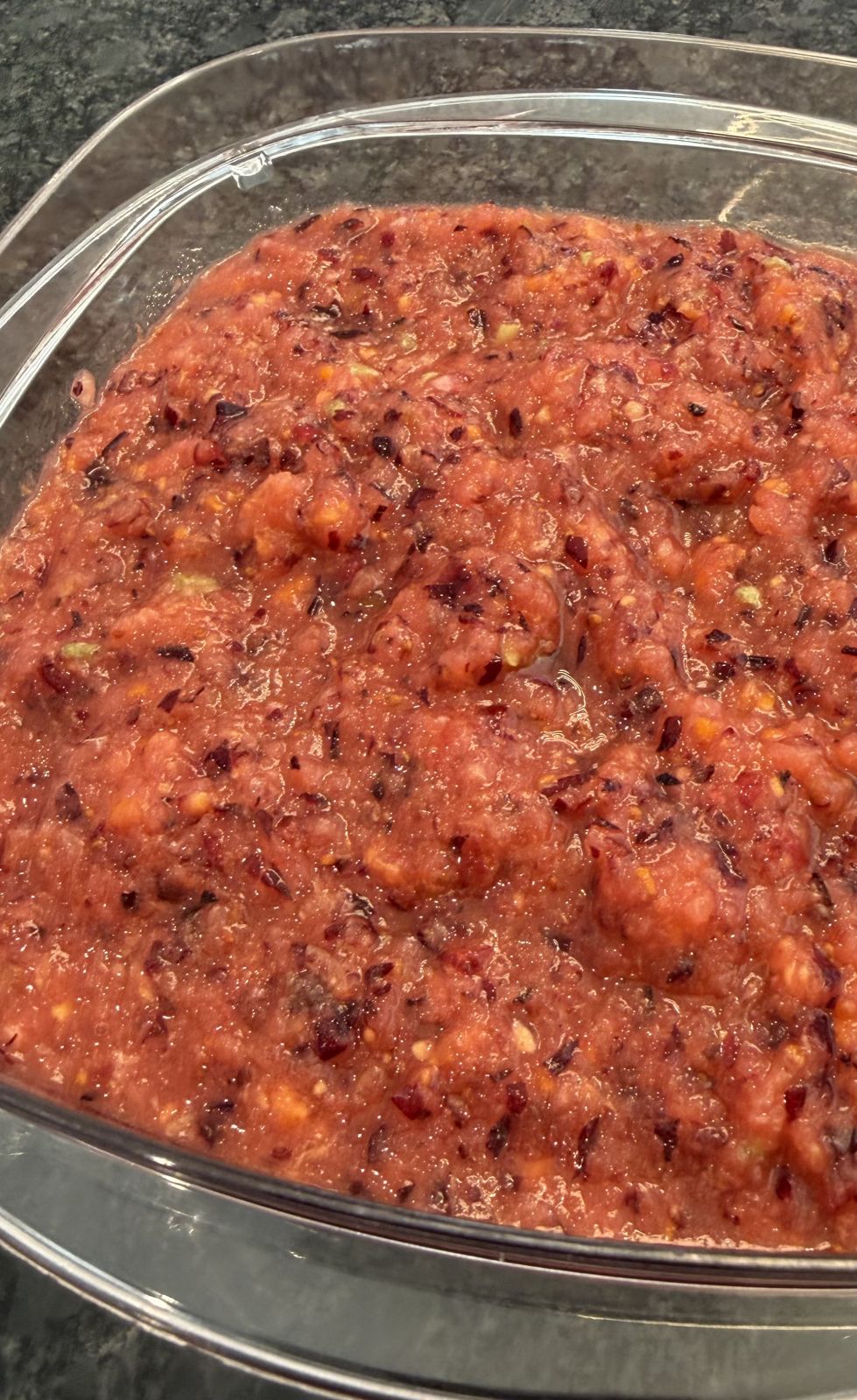 Bright cranberry-apple-orange relish in a bowl.